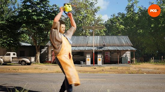Texas Chain Saw Massacre game review: Leatherface holds his chainsaw above his head in anger, as he stands in front of the gas station, a off-white Chevy truck parked outside. 