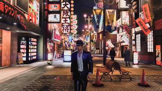 Kazuma Kiryu strutting his stuff in a stylish black suit on the city streets, looking for a Like A Dragon Gaiden release date.