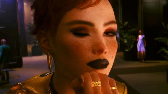 Cyberpunk 2077 patch 2.01 coming soon - A woman with freckles winks at you, her chin resting on her hand.