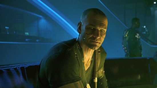 Cyberpunk 2077 Phantom Liberty mods: a man in a black v neck t shirt sat down, looking at you