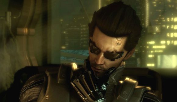 Deus Ex Thief Steam sale: a man with sunglasses and black hair raises his hand to his chin, contemplating