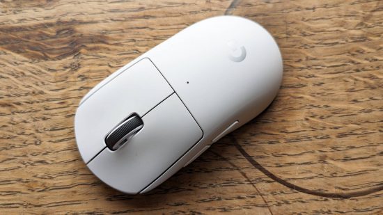 Logitech G Pro X Superlight 2 gaming mouse review: a white Logitech mouse sits on a wooden surface.