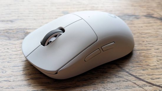 Logitech G Pro X Superlight 2 gaming mouse review: a white Logitech mouse is viewed from side on on a wooden surface.