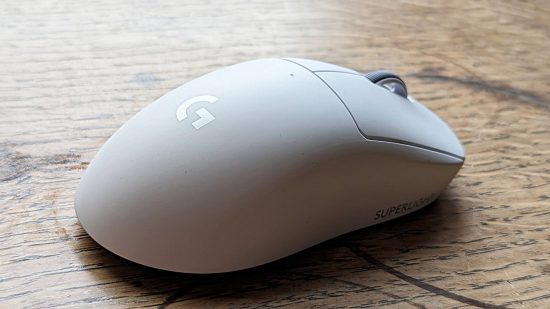 Logitech G Pro X Superlight 2 gaming mouse review: a white Logitech mouse, viewed from behind, sits on a wooden surface.