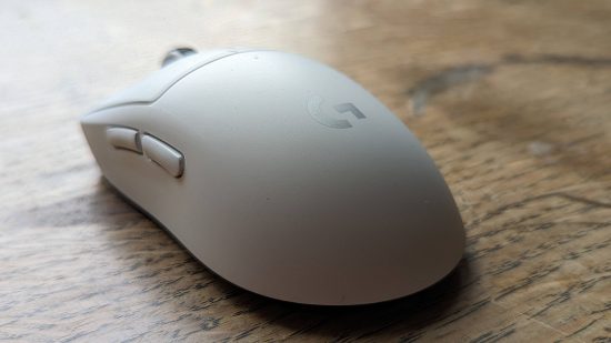 Logitech G Pro X Superlight 2 gaming mouse review: a white Logitech mouse, viewed from behind, sits on a wooden surface.