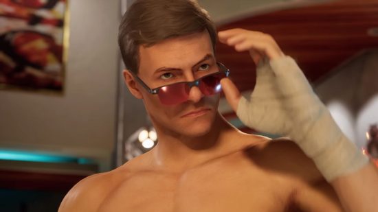 Mortal Kombat 1 Ed Boon Street Fighter: a shirtless man with combed over brown hair reaches to take of red tinted glasses with a bandaged up hand
