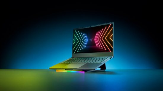 A Razer Blade laptop sat upon an angled plinth with a colorful Razer logo displayed on the screen 