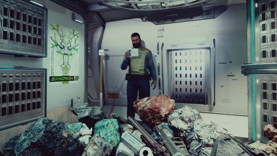 Bethesda clutter: a man stood reading a pad on a spaceship, with piles of clutter in front of him