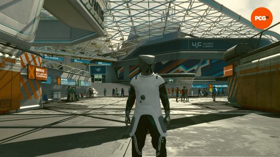 Starfield exploration planets: a man in a spacesuit stood in front of a city