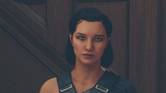 Starfield mod downloads: a woman in a dark blue dress and with shoulder length dark hair looks into the camera