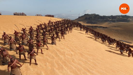 An army full of archers shoots high into the sky in a desert area at oncoming enemies