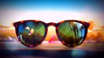 Dead Island 2 Epic Halloween sale: A pair of cracked cheetah-print sunglasses sitting against a blue sky backdrop
