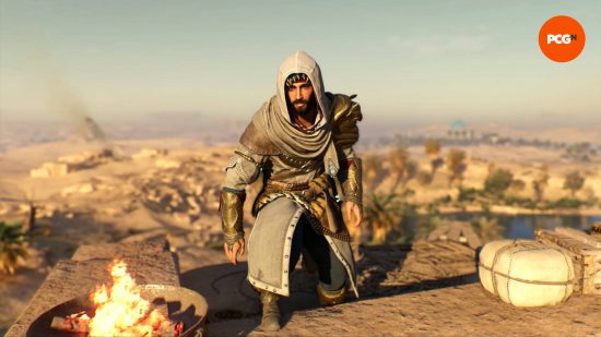 Basim is wearing the Rostam AC Mirage outfit while standing near a brazier. An oasis is in the desert behind him.