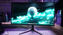 Alienware 360Hz QD-OLED new gaming monitors: a monitor displaying an alien appears on a desk.