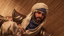 Basim crouches low to assess his next move with the best Assassin's Creed Mirage skills at his disposal.