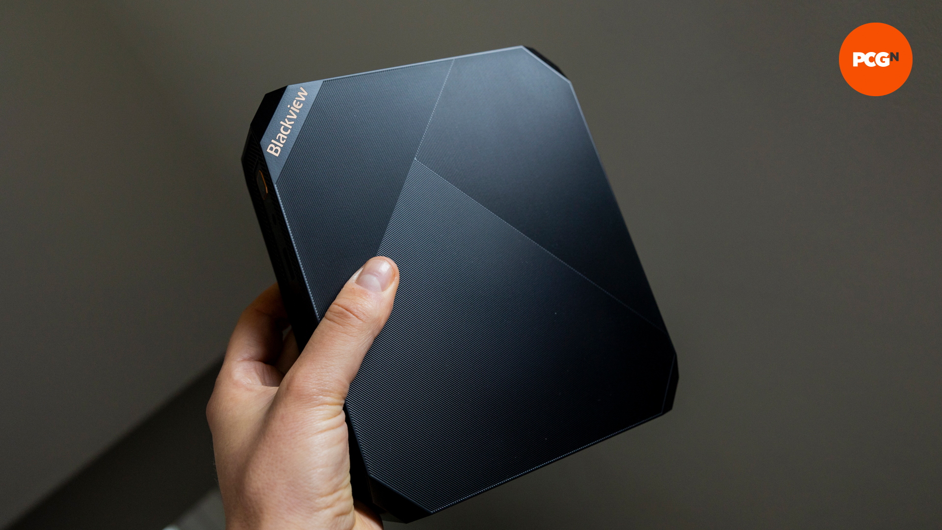 The Blackview MP200 mini gaming PC held in someone's hand to show the size