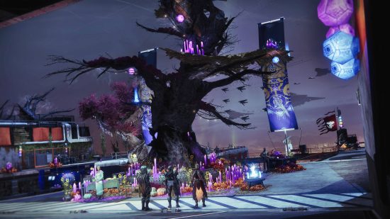 A tree in the middle of a tower as three people stare up at it. It's part of the Destiny 2 Festival of the Lost.