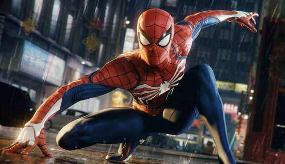 Grab up to 40% off the Marvel's Spider-Man series in huge Steam sale: Marvel character Spider-Man crouched in a landing position looking into the camera on a rainy city street