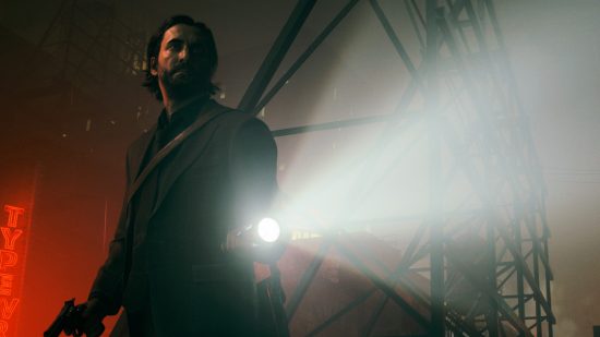 Alan Wake turns to look behind him, shining a flashlight in the dark in one of the best new games, Alan Wake 2.