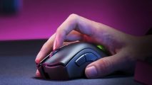 An image of the Razer DeathAdder V2 Pro wireless gaming mouse on a desk, with a pink/purple background.