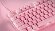 An image of the Razer Huntsman V2 tenkeyless gaming keyboard in Rose Quartz on a pink desk.