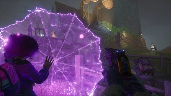 A black woman uses purple energy to conjure an umbrella as another player stands behind her with a gun at the ready