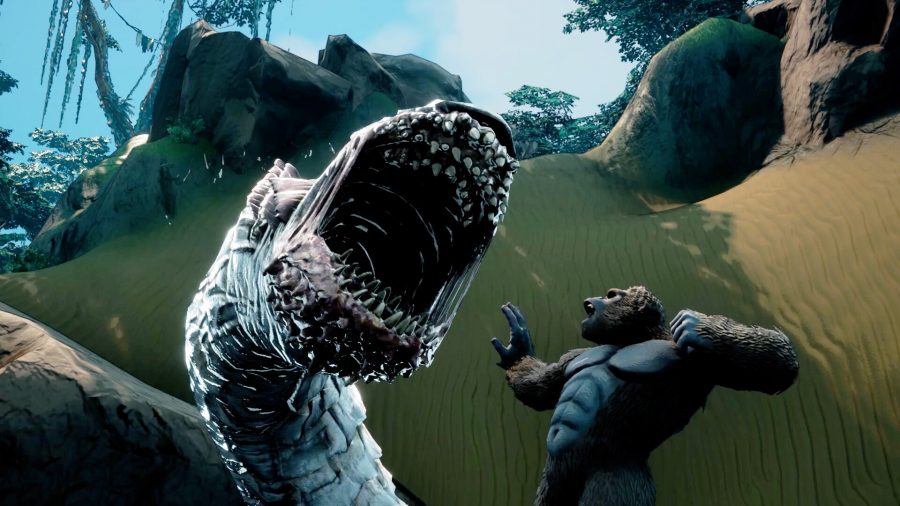 Skull Island: Rise of Kong: A huge ape looks up at a worm creature with rows of fangs