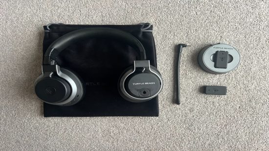 An image of the Stealth Pro headset with the wireless transmitter, both batteries, the microphone and included soft carry bag