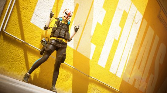 The Finals crossplay: a person wearing a mash, and tactical military gear thands in front of a yellow wall.