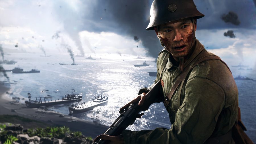 Battlefield V: A man wearing army gear and a helmet holds his gun, a naval war scene behind him