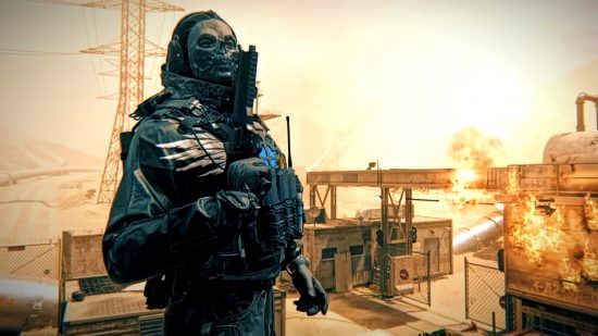 Modern Warfare 3 update: A man wearing SWAT-style military gear stands in front of a building explosion, his pistol facing up before his face