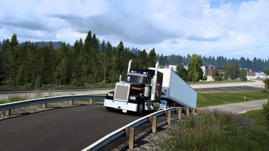 American Truck Simulator – Ein schwarzes Taxi mit einer weißen Frachtkiste fährt einen steilen Hügel in der PACCAR-Testanlage hinauf.