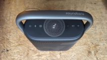 Anker Soundcore Motion X500 review: a black speaker with silver handle appears from above against a wooden surface.