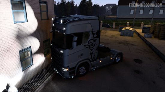 A truck shining its lights on a nearby wall