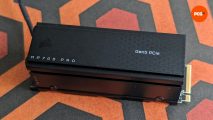 The Corsair MP700 Pro SSD, against a geometric background of red-black-orange patterns