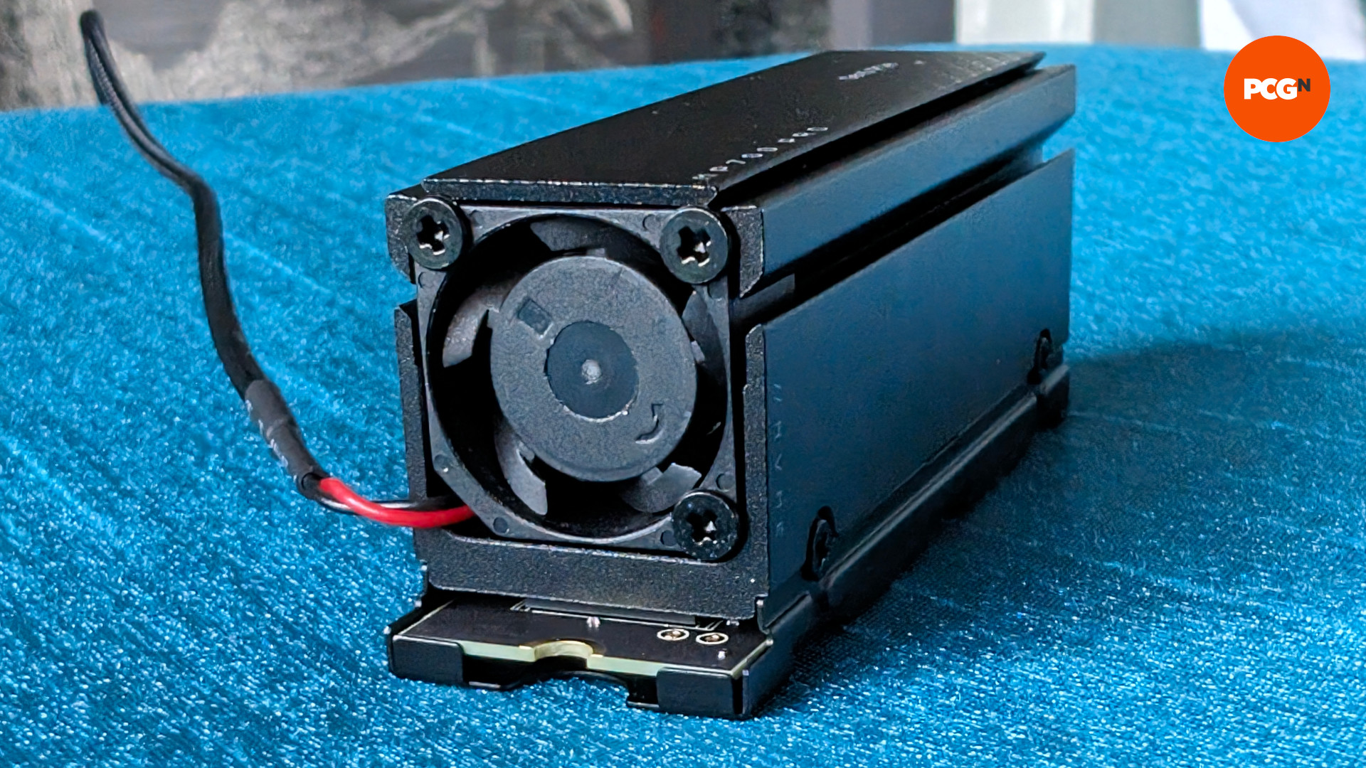 The Corsair MP700 Pro SSD, foucssing on its built-in air cooling solution, against a blue background