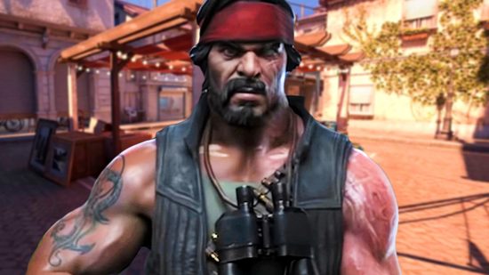 Coiunter-Strike 2 - A muscular man with a goatee wearing a red headband stands in a town square.