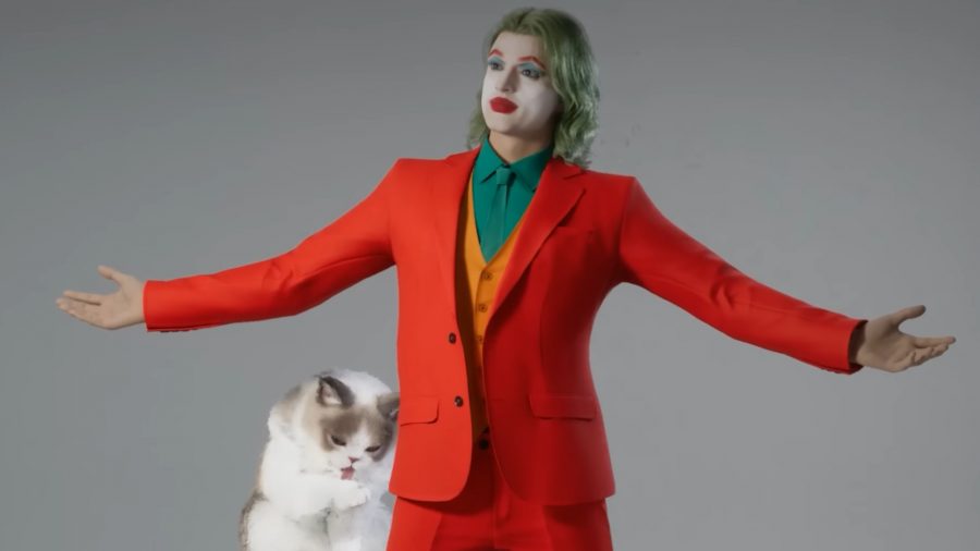 inZOI - A long-haired man dressed as The Joker stands, arms spread wide, next to a fluffy cat.