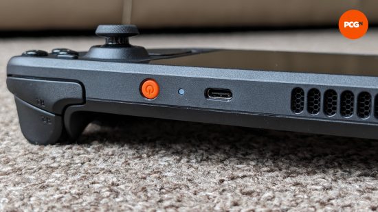 The top of the Steam Deck OLED, featuring its distinctive orange-colored power button