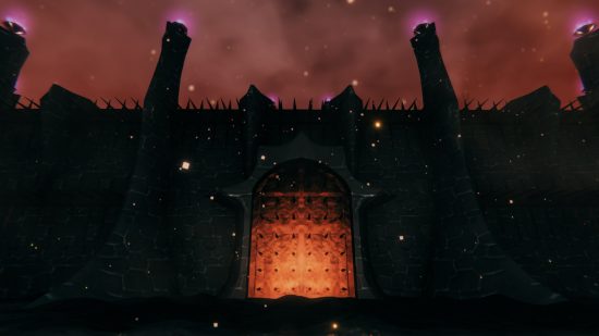 Valheim Ashlands update - A giant fortress with spiked gate lit up in orange.