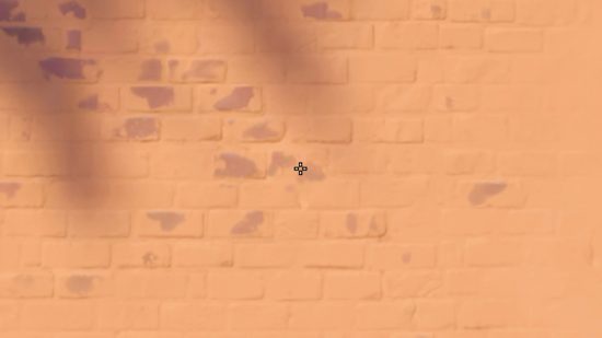 mistic Valorant crosshairs: A white cross with a black outline on a wall in Valorant.