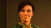 Starfield 2024: A woman with very short hair smiles ahead, wearing a green vest and dark eyeliner