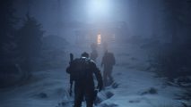 A group of people wearing winter clothes traveling up a snowy hill to a lamp-lit shack.