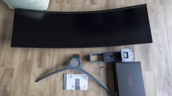 The The AOC Agon AG493UCX2 unassembled on a wooden floor