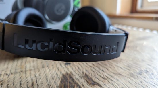 LucidSound LS100X review: a black gaming headset sits on a wooden table.