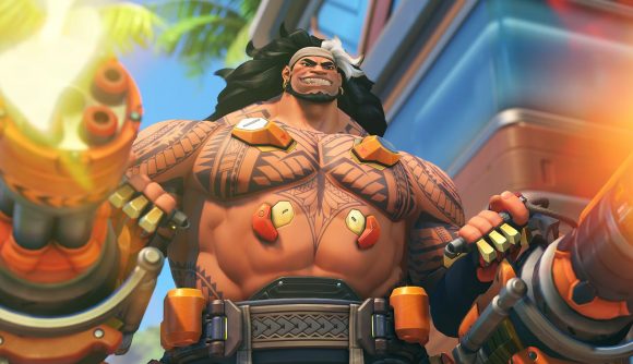 Overwatch 2 tier list: Mauga stands bare chested as he fires two large machine guns from each hand