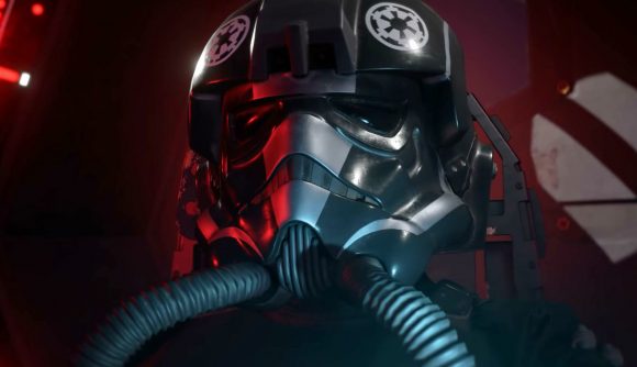 A black-helmeted Star Wars imperial Tie pilot inside a red-lit Tie Fighter.