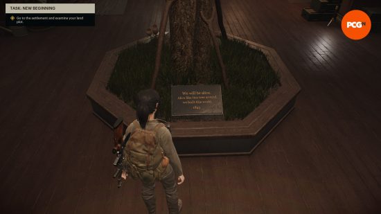 A woman in combat gear looks down at a tree in the middle of a room with a plaque from 1845