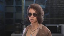 The Day Before melee: a woman with short brown hair, sunglasses, and a brown unbuttoned shirt on