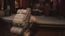 A man in a backpack sits at a bar waiting for The Day Before server status to stabilize